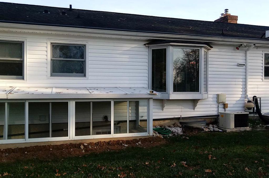 Rear of house before master bedroom addition. Basement stairs were moved and replaced with a Bilco egress window.
