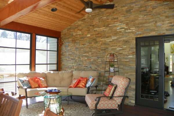 Luxury screened porch with stonework and hardwood