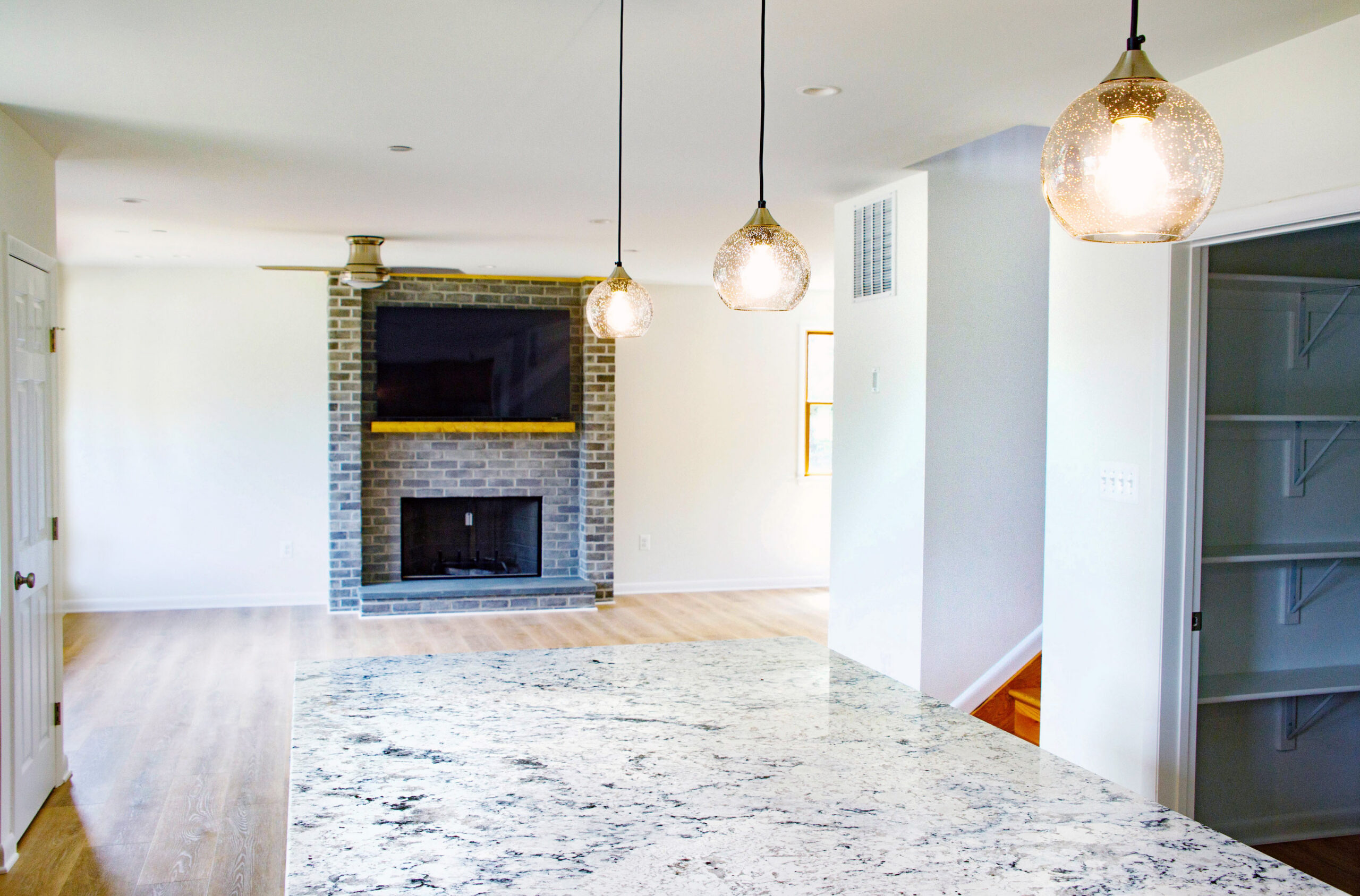 Art glass pendant lights over the large kitchen island