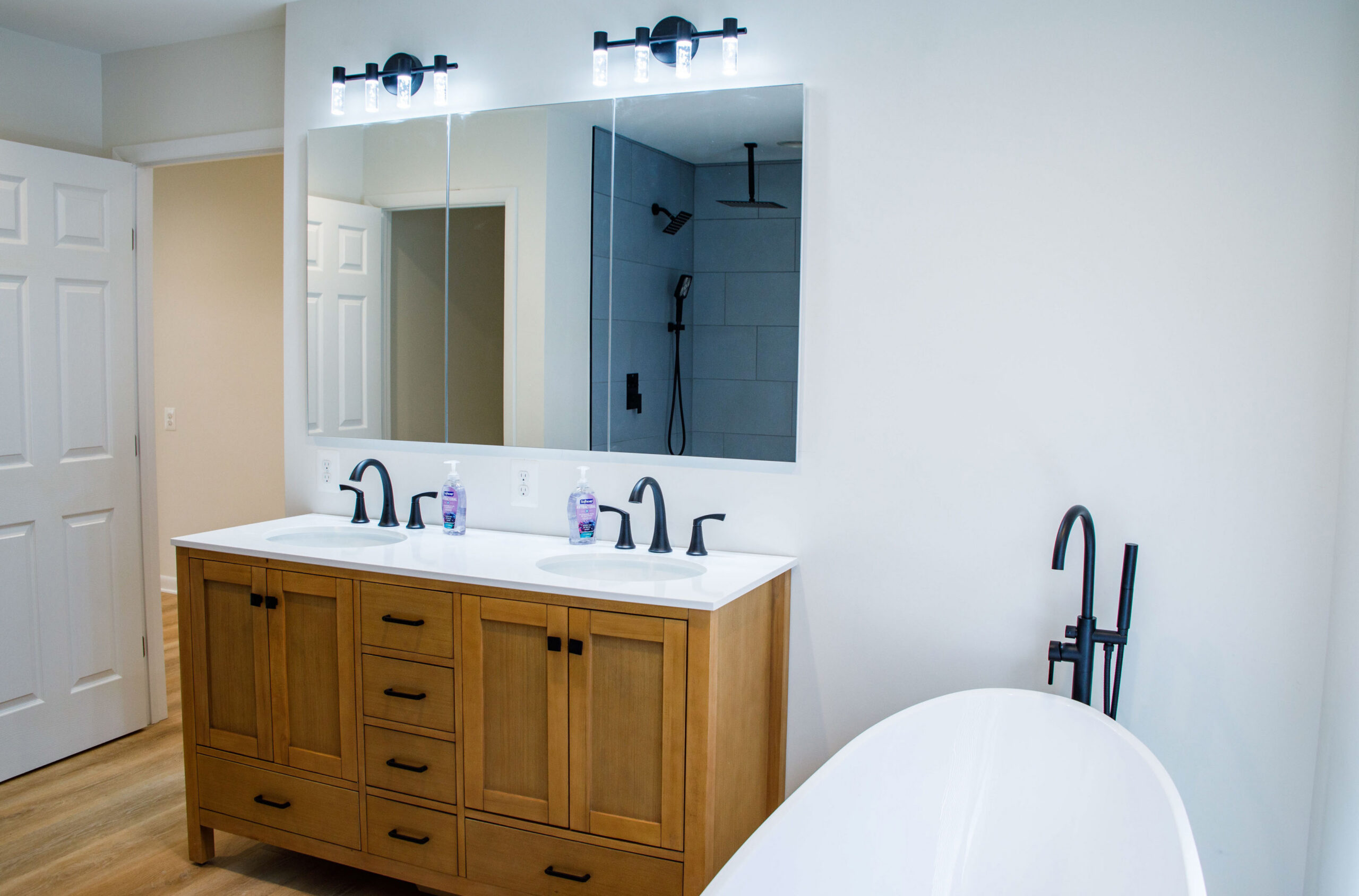 Upstairs bathroom with freestanding tub and custom tiled shower