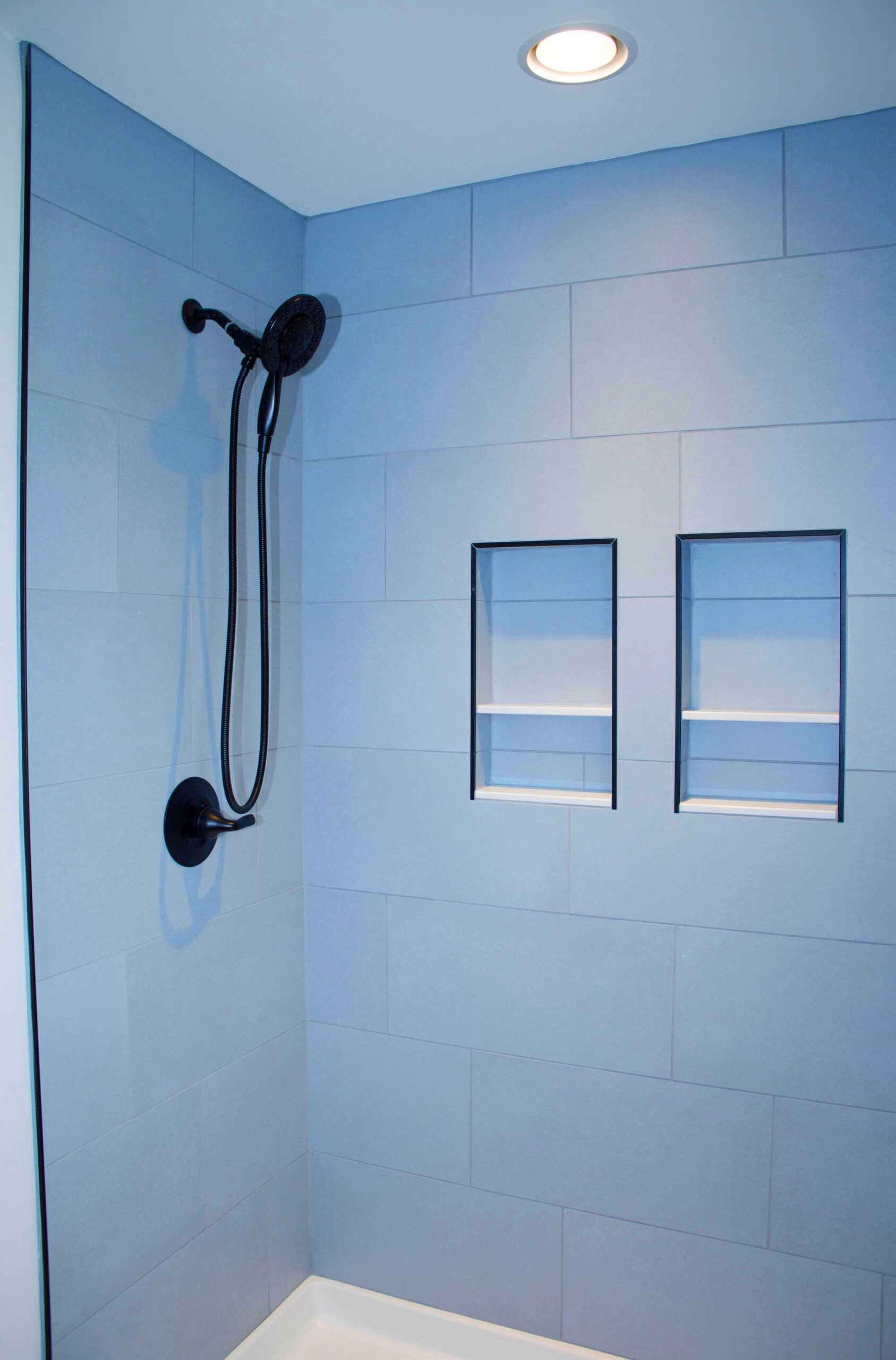 Custom tiled shower in hall bathroom